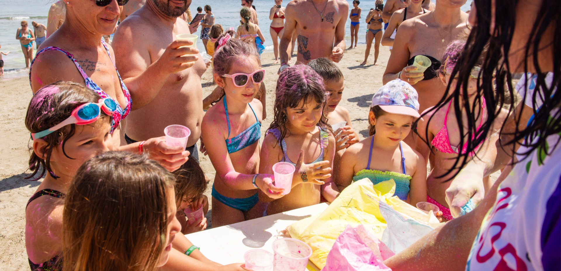 Bambini felici giocano sulla spiaggia, colori vivaci e risate.