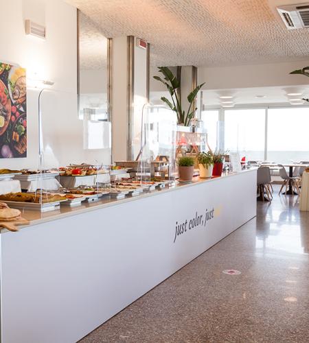 Elegant buffet with colorful food, bright and welcoming atmosphere.