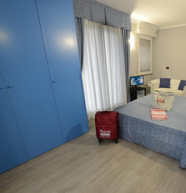 Camera accogliente con arredi blu, atmosfera rilassante e dettagli moderni.